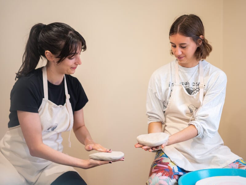 Women smiling with hand building clay